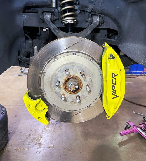 slotted rotor and hub with the caliper off during a brake job at Tizzano Automotive