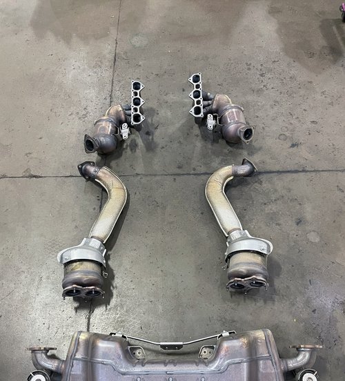 exhaust manifolds, catalytic converters and downpipes removed for replacement at Tizzano Automotive