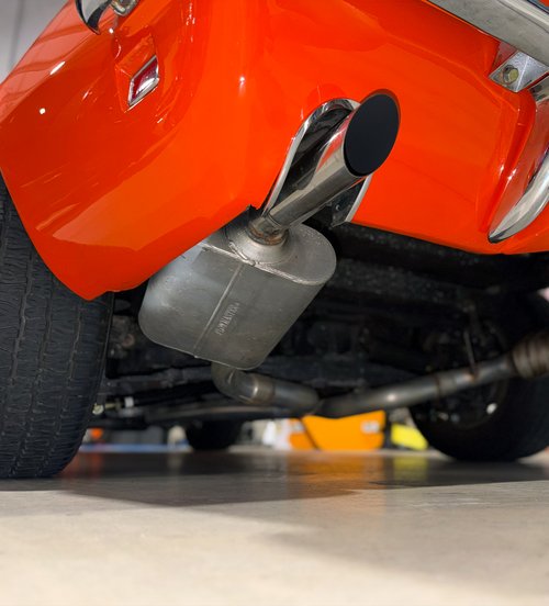 chrome tailpipe and muffler under a vehicle at Tizzano Automotive in Plain City, OH