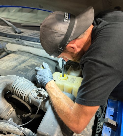 Nick Tizzano working in an engine bay at Tizzano Automotive in Plain City, OH